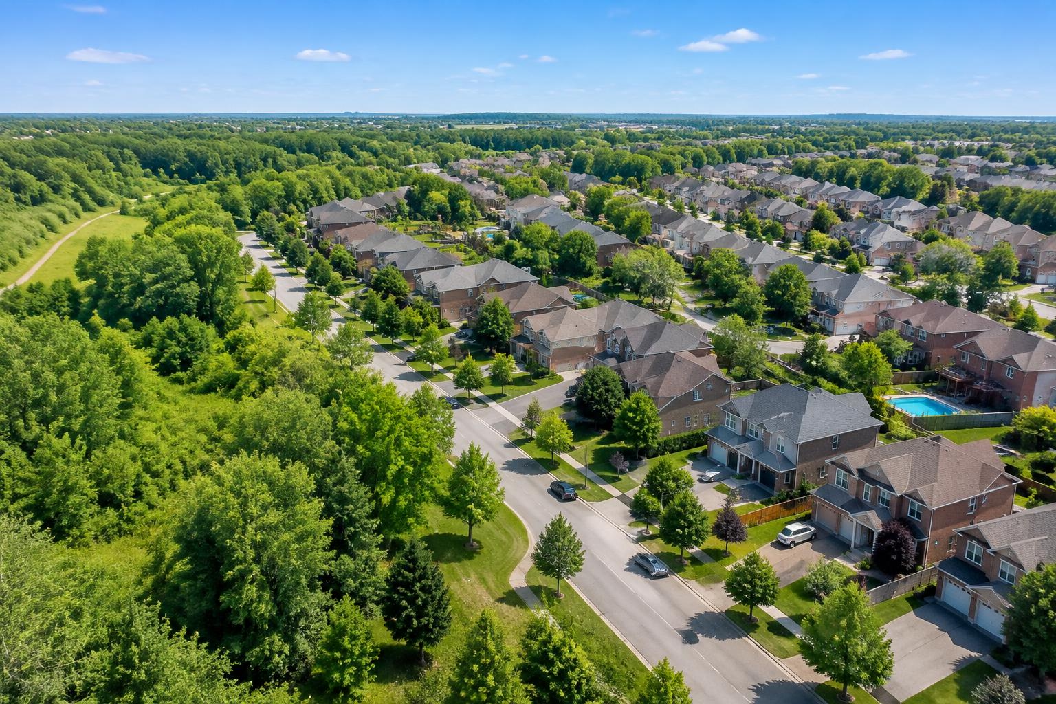 Illustrative aerial view of a green Ontario residential neighbourhood in summer daylight